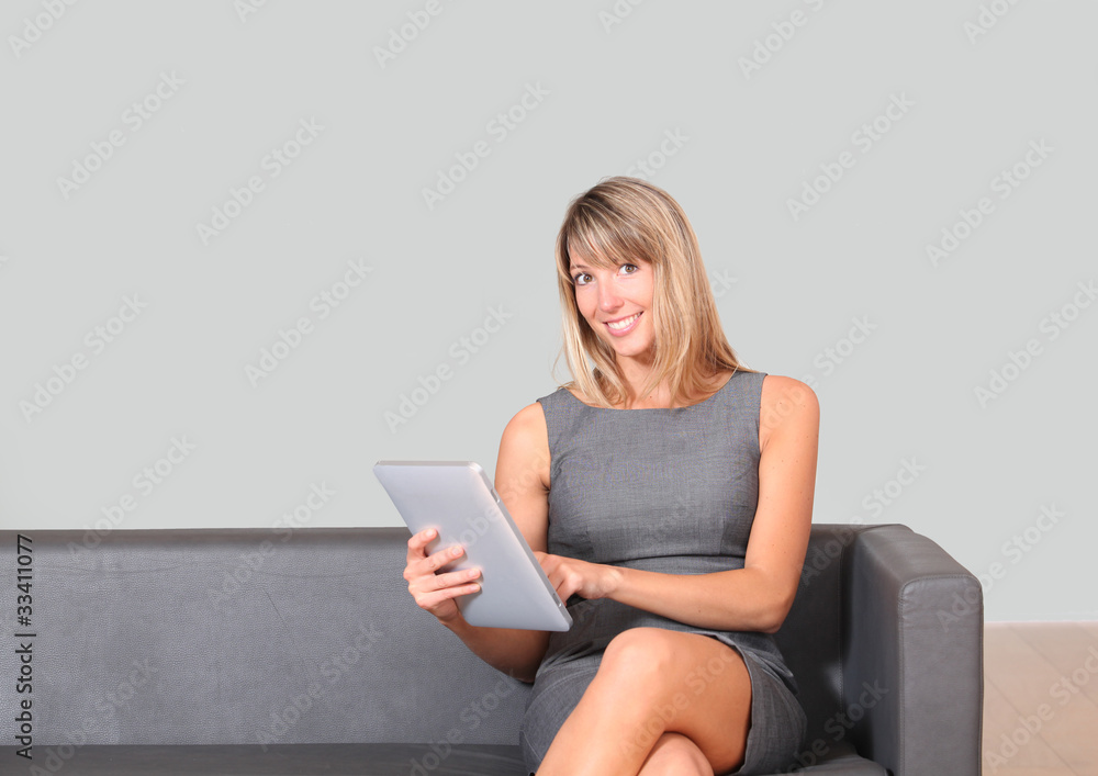 Businesswoman using electronic tablet in waiting room Businesswoman using electronic tablet in waiting room