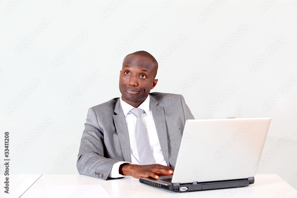 Businessman in office with thoughtful look Businessman in office with thoughtful look