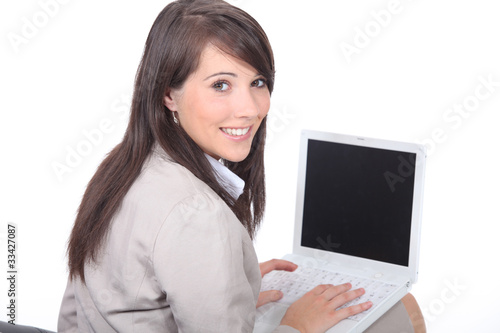 Brunette working on laptop computer