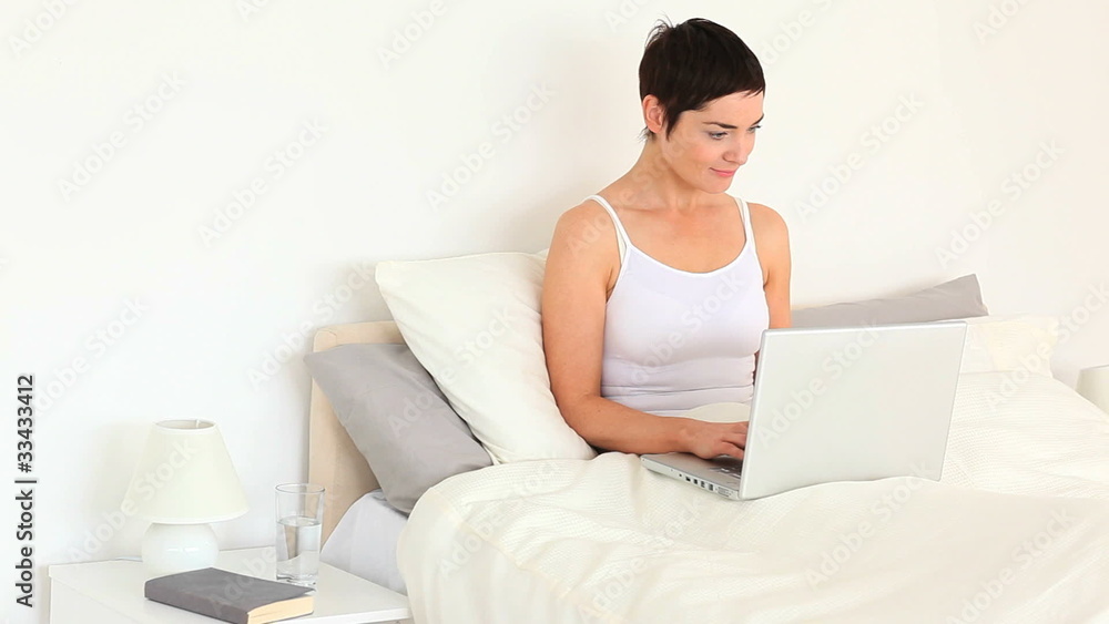 Brunette woman relaxing with a computer Brunette woman relaxing with a computer