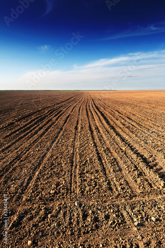 Ploughed field under blue sky