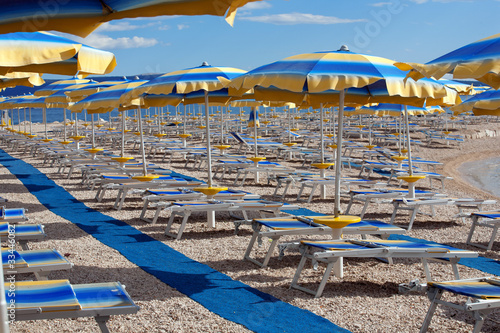 Beach with perfectly parallel lines of parasols