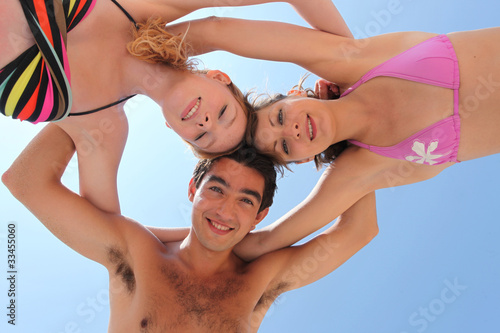 Quirky shot of three young people on the beach