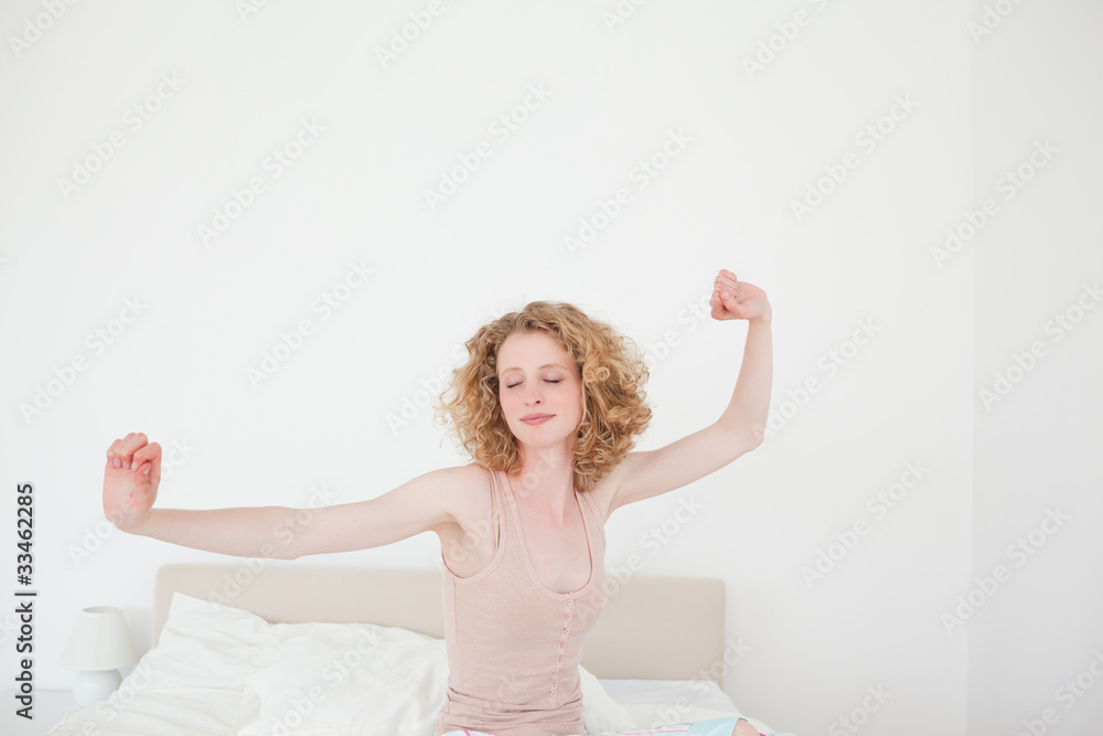 Gorgeous blonde female stretching in her bedroom Gorgeous blonde female stretching in her bedroom