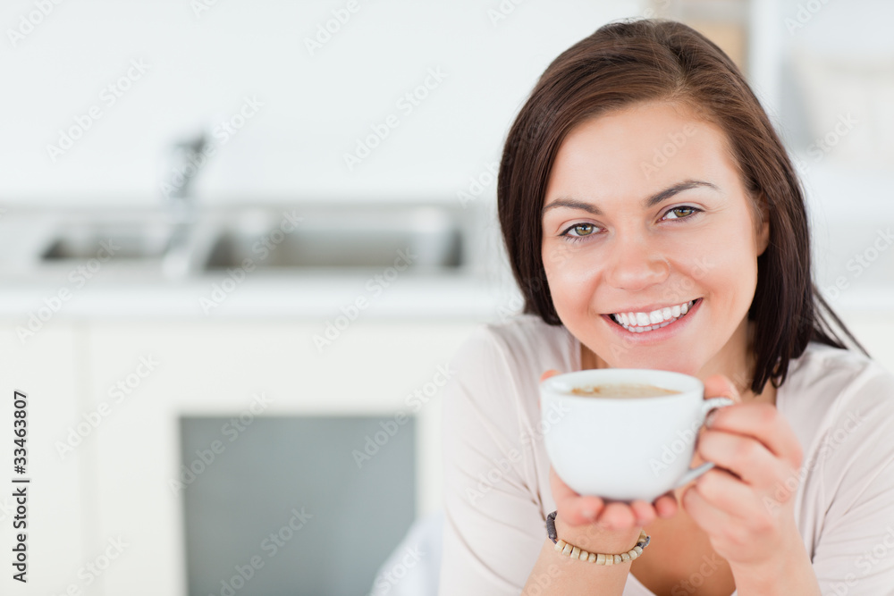 Close up of a smiling brunette having a coffee Close up of a smiling brunette having a coffee