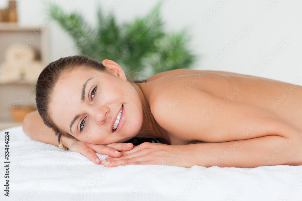 Woman lying on her belly waiting for a massage Woman lying on her belly waiting for a massage