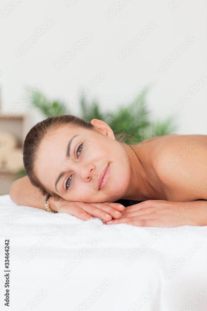 Portrait of a woman lying on her belly looking at the camera Portrait of a woman lying on her belly looking at the camera