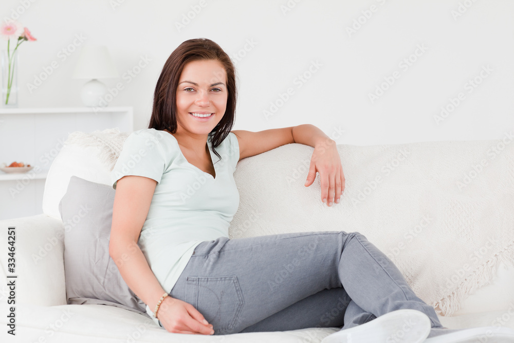 Beautiful woman sitting on a couch Beautiful woman sitting on a couch
