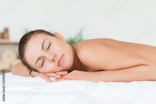 Woman lying on her belly closing her eyes