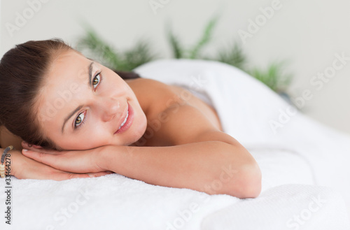 Close up of a cute woman lying on a massage table