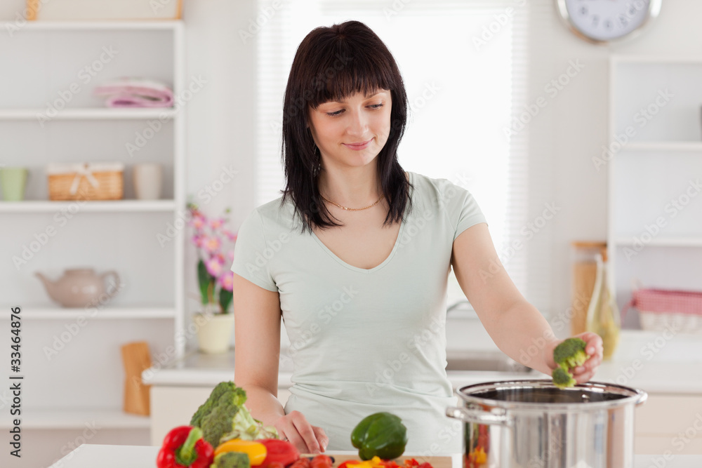 Attractive brunette woman cooking vegetables Attractive brunette woman cooking vegetables
