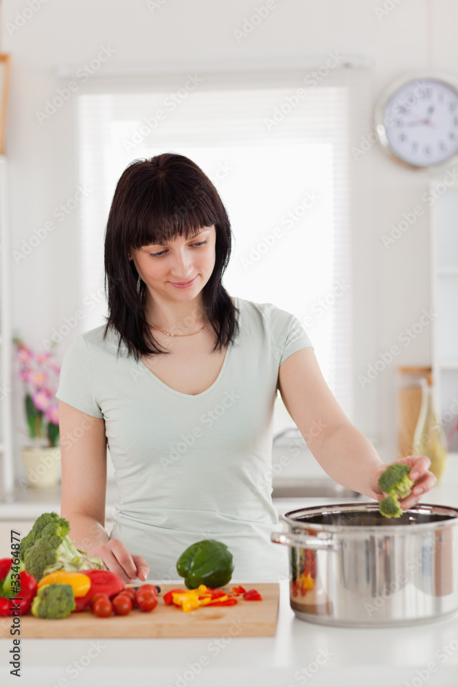 Beautiful brunette woman cooking vegetables Beautiful brunette woman cooking vegetables