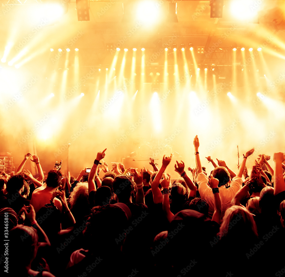 concert crowd in front of bright yellow stage lights Stock Photo | Adobe  Stock
