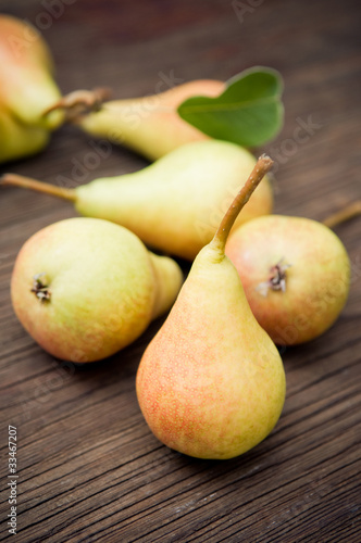 Organic pears on wooden background