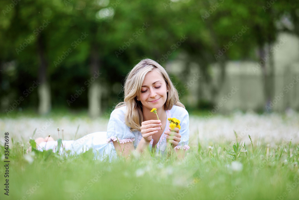 Fototapeta premium Young blond woman in the park