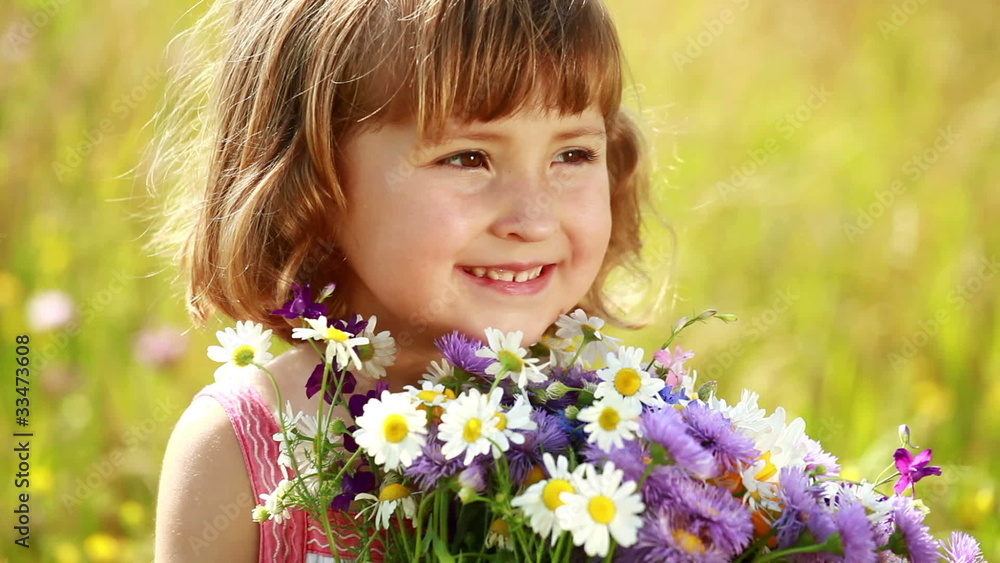 Little girl with flowers laughing Little girl with flowers laughing