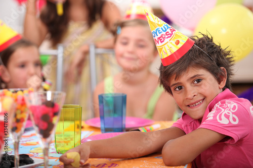 portrait of a little boy at a birthday party