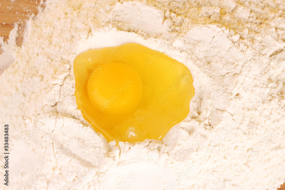 egg and flour on wooden background egg and flour on wooden background