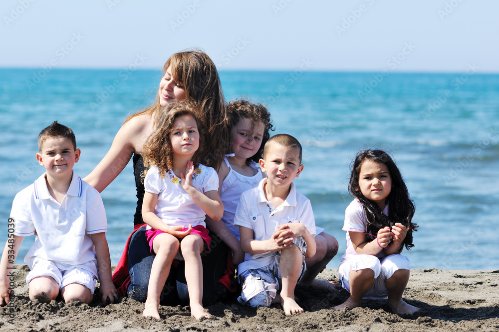 group portrait of childrens with teacher on beach group portrait of childrens with teacher on beach