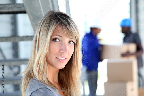 Portrait of beautiful woman standing in warehouse