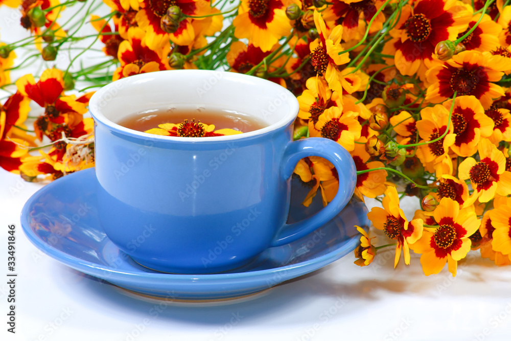 The blue cup of tea with nice flowers The blue cup of tea with nice flowers
