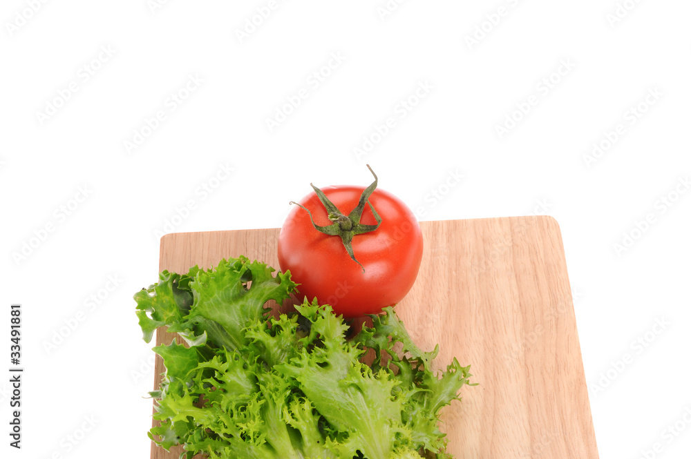 salad and tomato on cutting board isolated on white salad and tomato on cutting board isolated on white