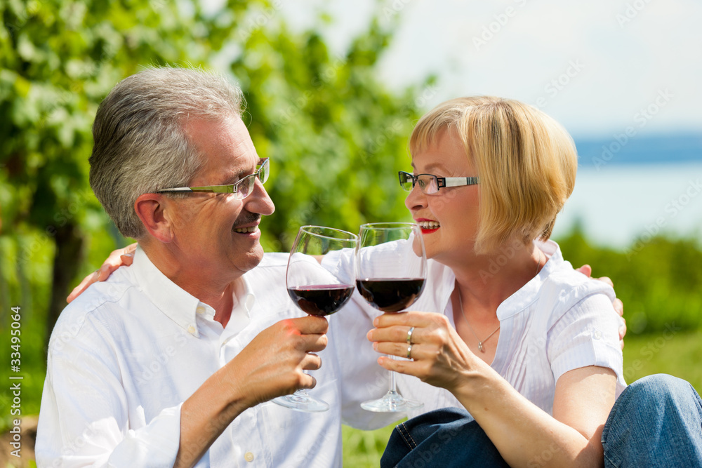 Happy couple drinking wine at lake in summer Happy couple drinking wine at lake in summer