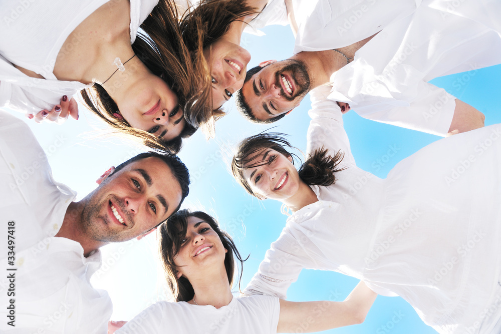 Group of happy young people in circle at beach Group of happy young people in circle at beach
