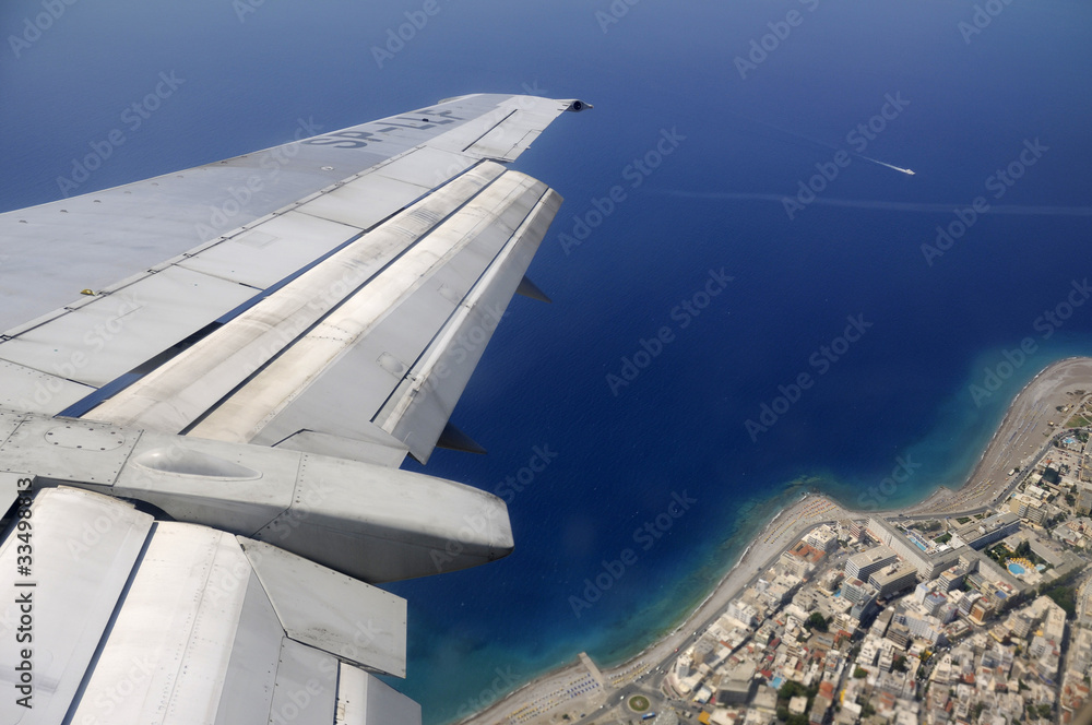 Sky, sea and island seen through window of an aircraft Sky, sea and island seen through window of an aircraft