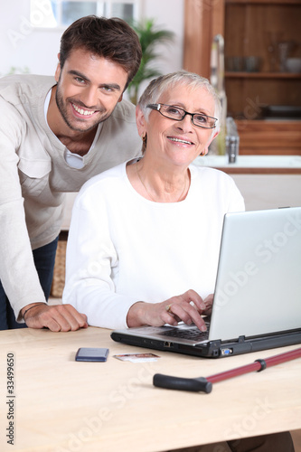 Son helping Mother on laptop