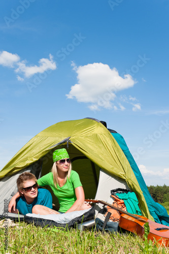 Camping couple lying inside tent summer countryside