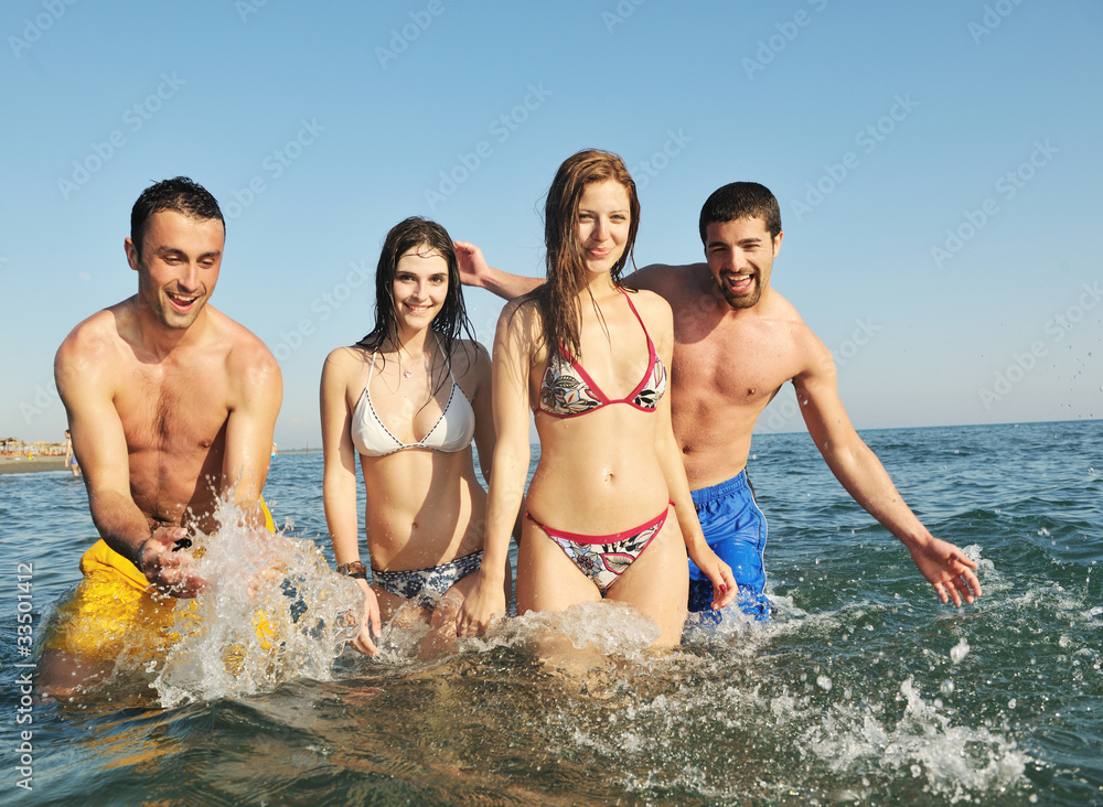 happy young  people group have fun on beach