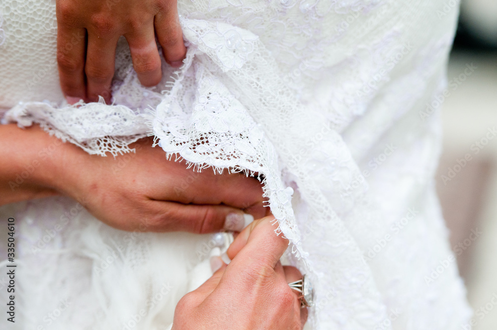 Fototapeta premium Fixing a wedding dress