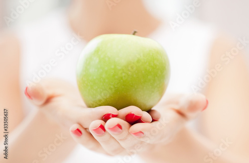 female hands with green apple