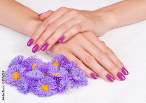 Magenta fingernails and purple flowers