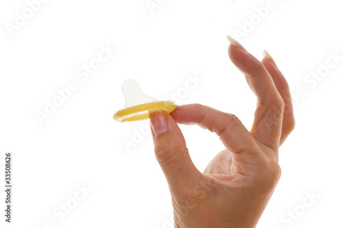 womans hand holding a condom