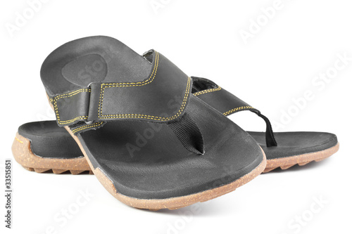 pair of black flip flops isolated on white background