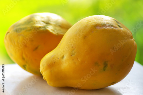 papayas on a green background