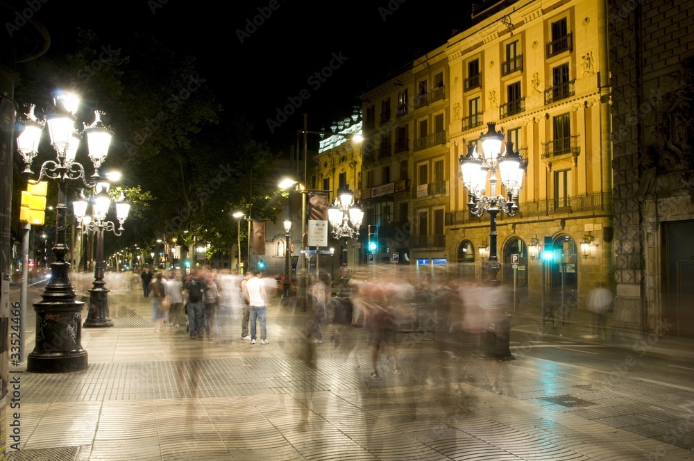 night scene tourists walking La Rambla Barcelona