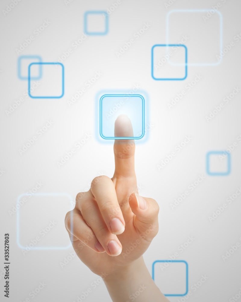 Hand pressing virtual button on futuristic holographic screen Hand pressing virtual button on futuristic holographic screen