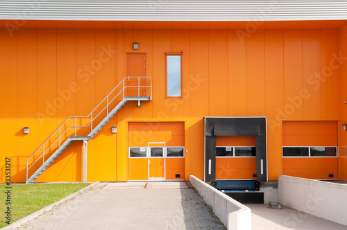 orange building with loading dock and fire escape stair