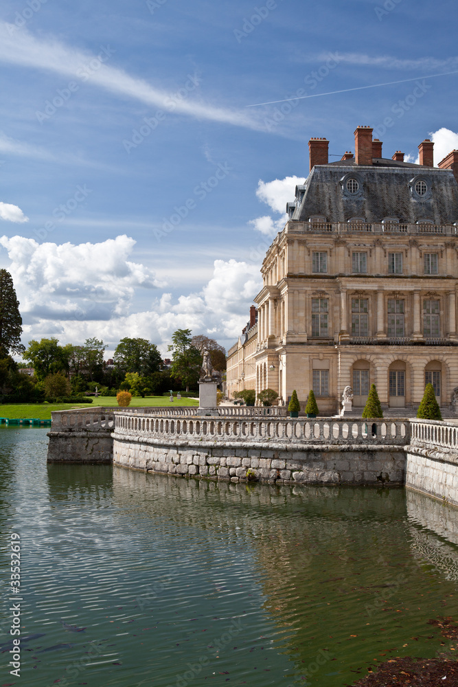 Medieval royal castle Fontainebleau and lake near Paris