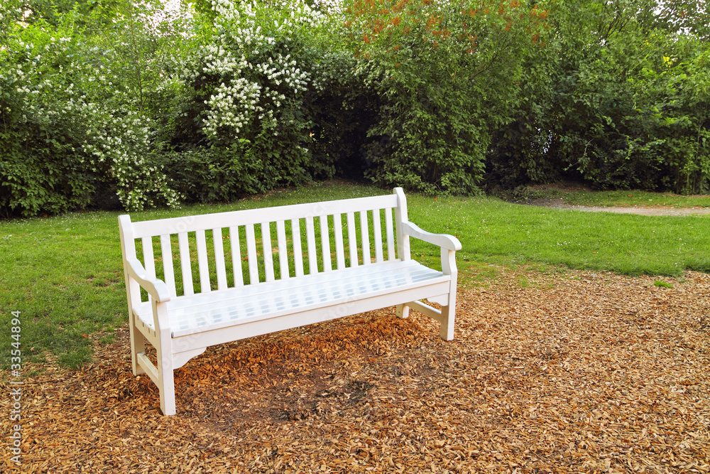 Empty white wooden bench in park