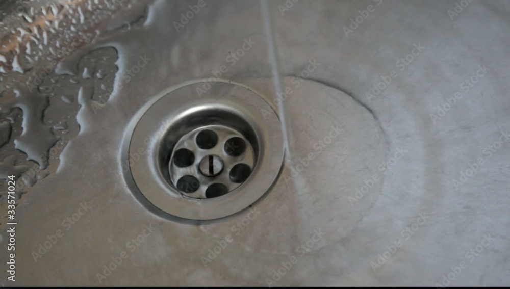Water flowing in a kitchen sink. Water flowing in a kitchen sink.
