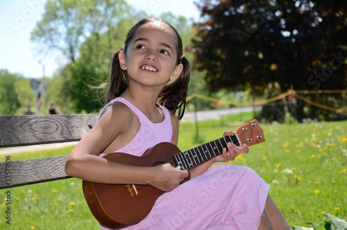 Little Girl Playing the Ukulele