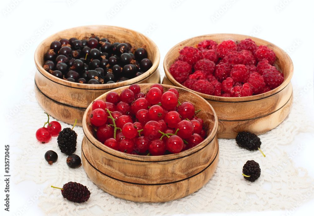 fresh berries in wooden bowls fresh berries in wooden bowls