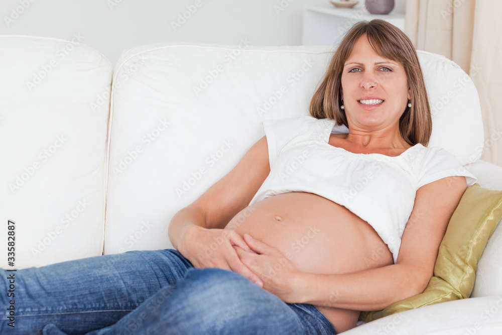 Beautiful pregnant woman posing while lying Beautiful pregnant woman posing while lying