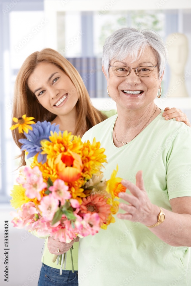 Happy senior mother with flowers at mother's day Happy senior mother with flowers at mother's day