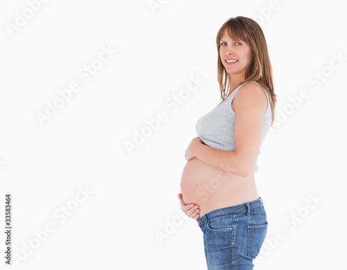 Side view of a beautiful pregnant woman caressing her belly whil © WavebreakmediaMicro