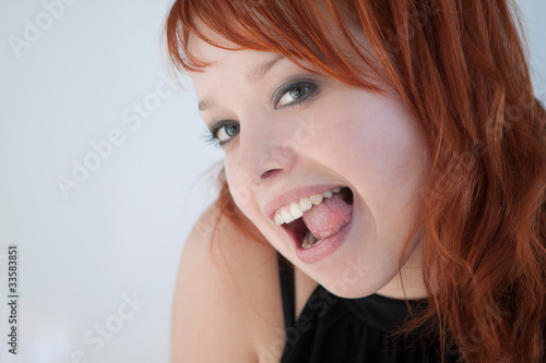 funny redhead girl hamming and make faces